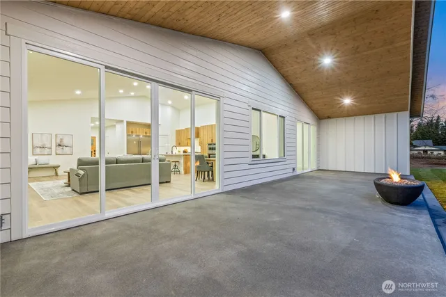 a view of a livingroom with furniture and floor to ceiling window
