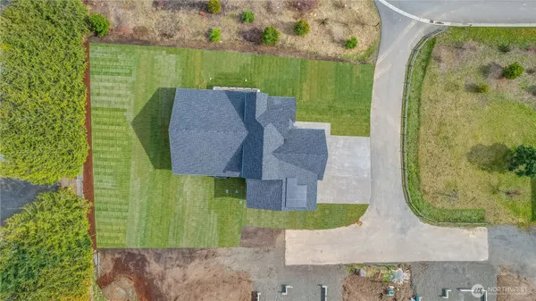 an aerial view of a house with garden space and swimming pool