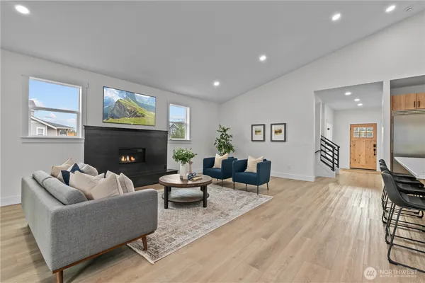 a living room with furniture a fireplace and a flat screen tv