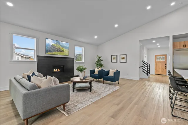 a living room with furniture a fireplace and a flat screen tv