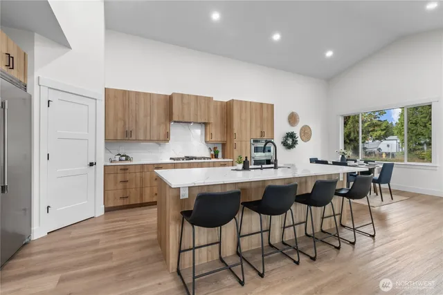 a kitchen with a table chairs sink and cabinets