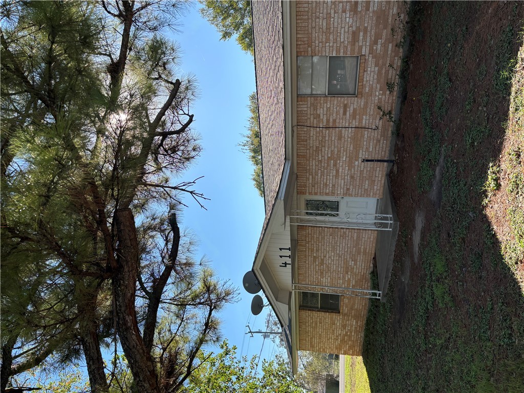 411 Hickory Street Calvert, TX 77837 - Photo 1 of 9 a front view of a house with a garden