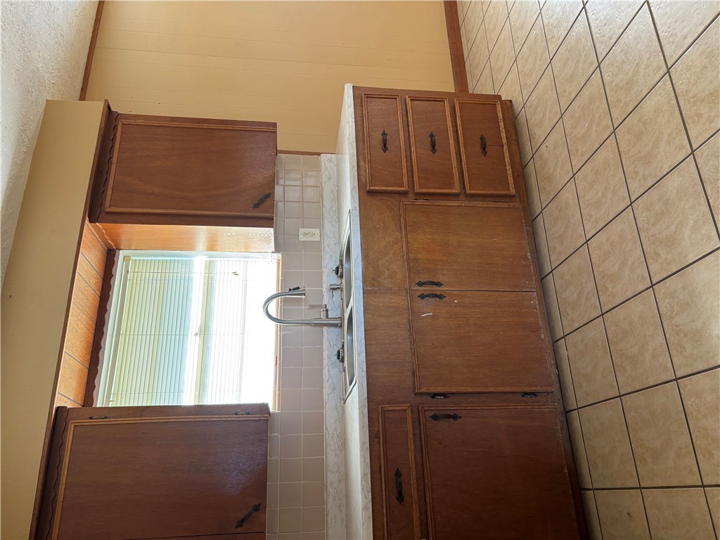 411 Hickory Street Calvert, TX 77837 - Photo 5 of 9 a kitchen with a sink and cabinets