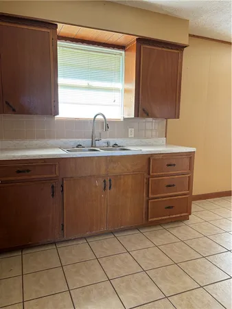 a kitchen with a sink and cabinets