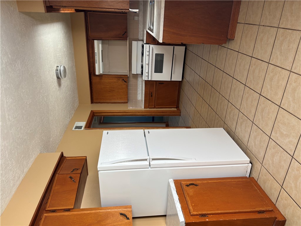 411 Hickory Street Calvert, TX 77837 - Photo 6 of 9 a kitchen with a refrigerator and a stove
