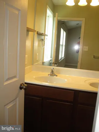a bathroom with a double vanity sink and a mirror