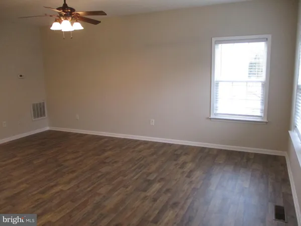 a view of a kitchen cabinets and wooden floor