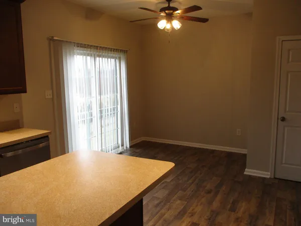 a kitchen with stainless steel appliances granite countertop a stove a sink dishwasher a refrigerator and a microwave oven with wooden floor