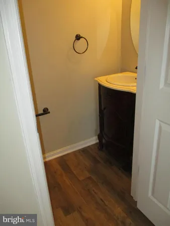 a bathroom with a granite countertop toilet and a sink