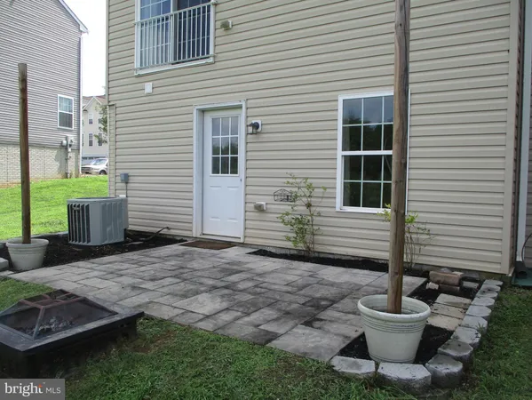 a view of a patio with a chairs and a potted plant