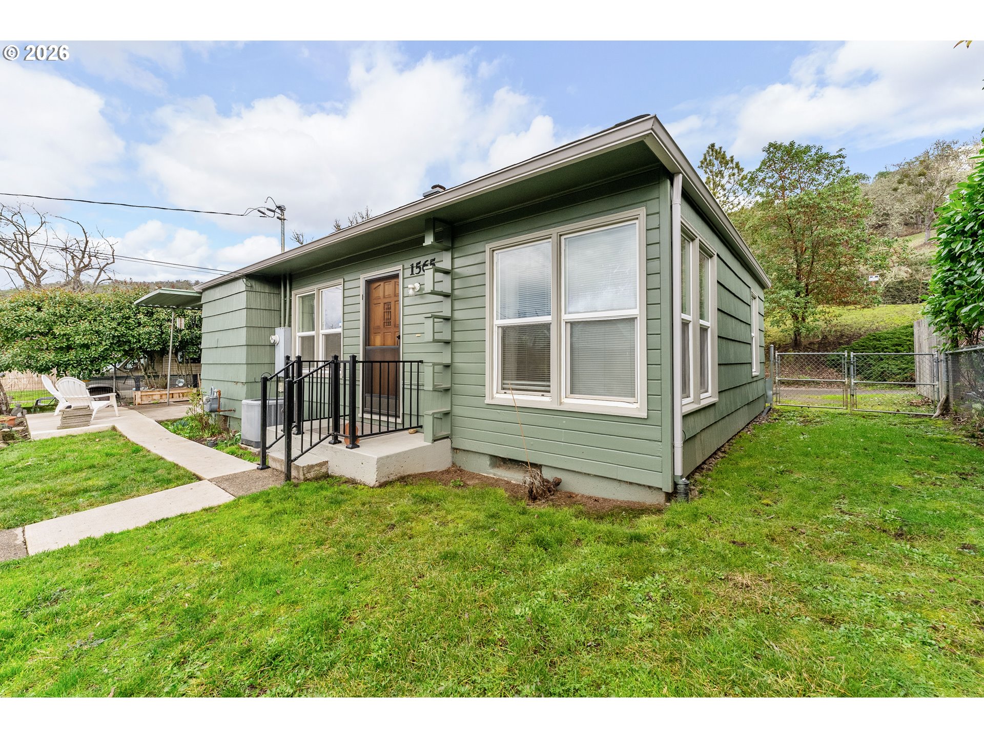1565 Northeast Todd Street Roseburg, OR 97470 - Photo 2 of 25 a view of a house with a yard and deck