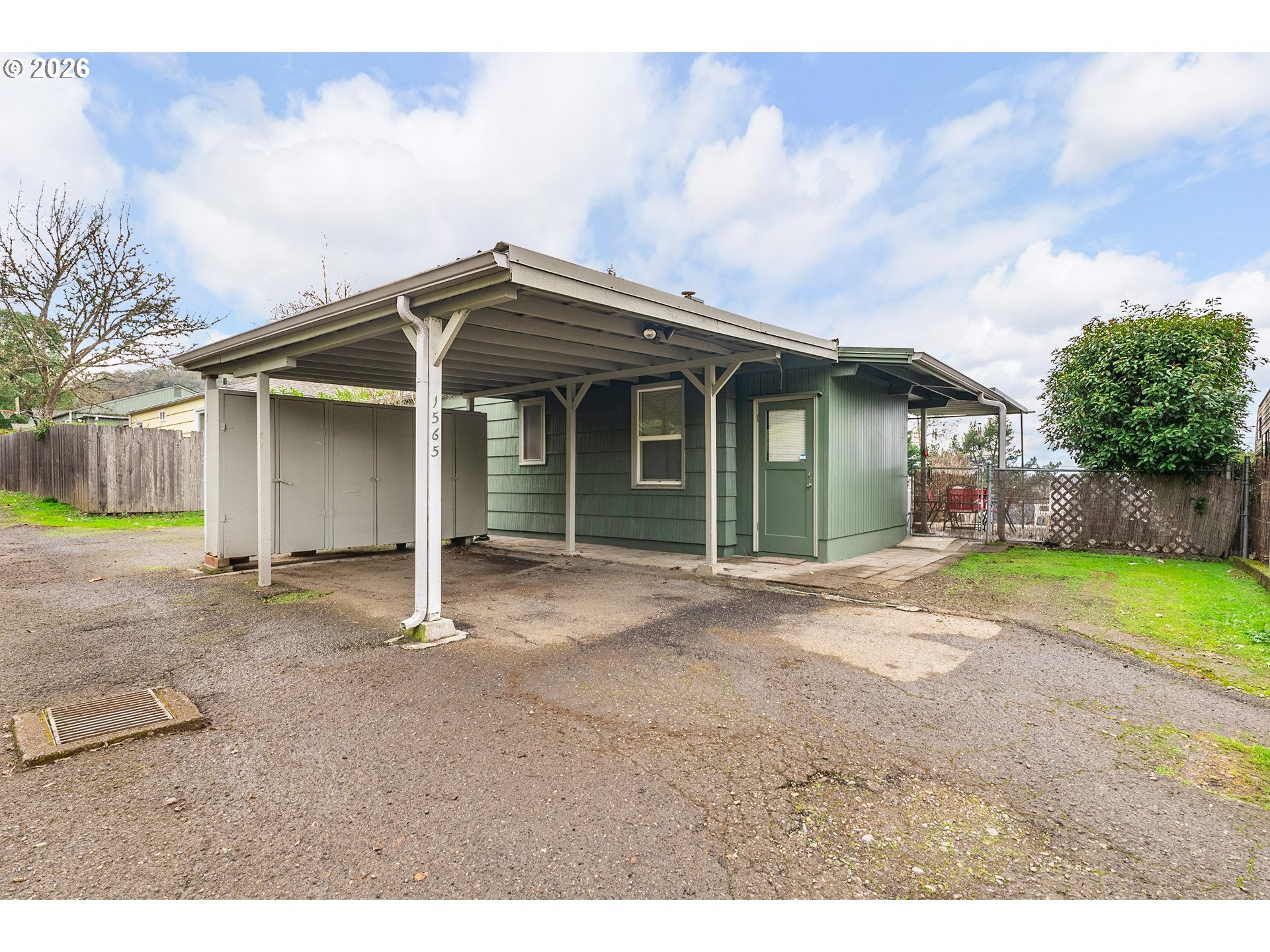 1565 Northeast Todd Street Roseburg, OR 97470 - Photo 22 of 25 a front view of a house with a garden and yard