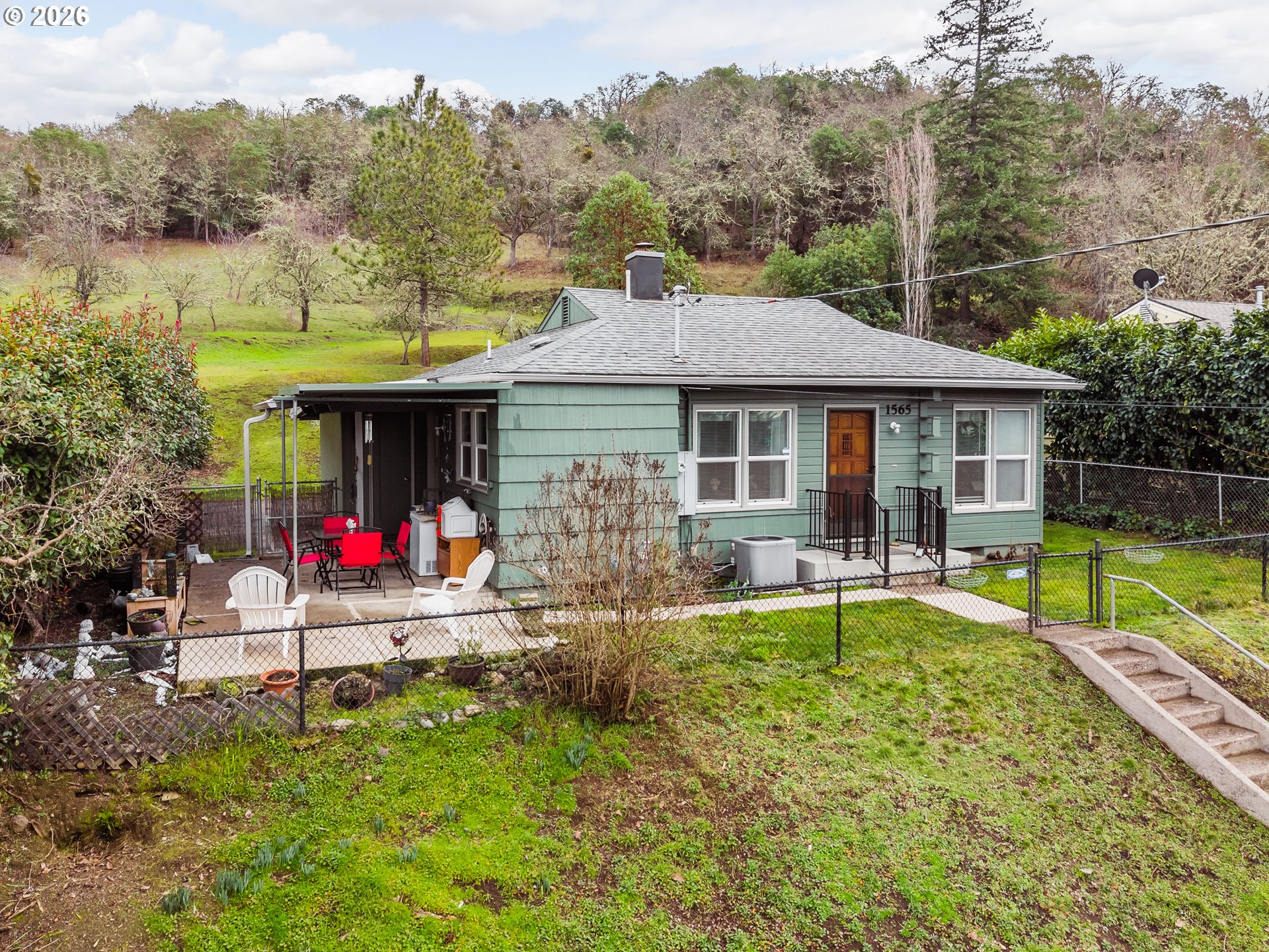 1565 Northeast Todd Street Roseburg, OR 97470 - Photo 25 of 25 a view of house with a swimming pool and a yard
