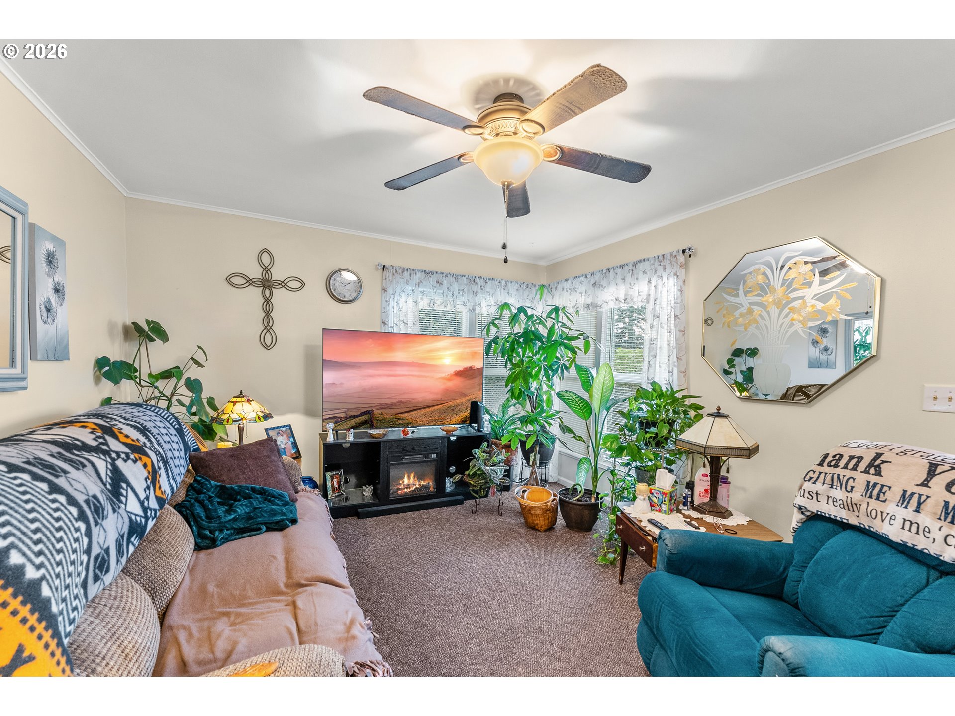 1565 Northeast Todd Street Roseburg, OR 97470 - Photo 4 of 25 a living room with furniture a fireplace and a chandelier