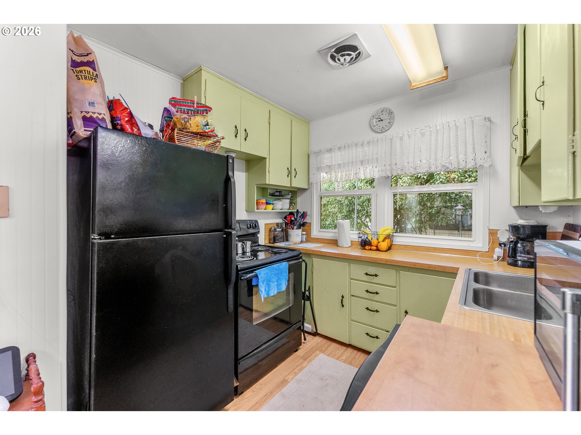 1565 Northeast Todd Street Roseburg, OR 97470 - Photo 7 of 25 a kitchen with granite countertop a refrigerator and a sink