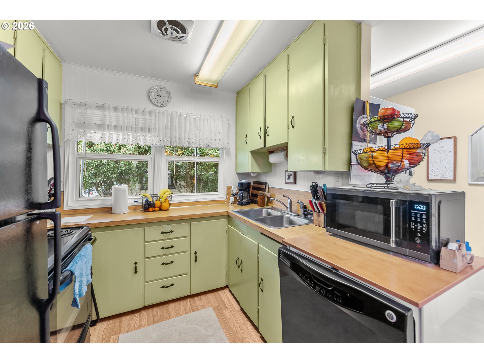 1565 Northeast Todd Street Roseburg, OR 97470 - Photo 9 of 25 a kitchen with stainless steel appliances a stove a sink cabinets and a window