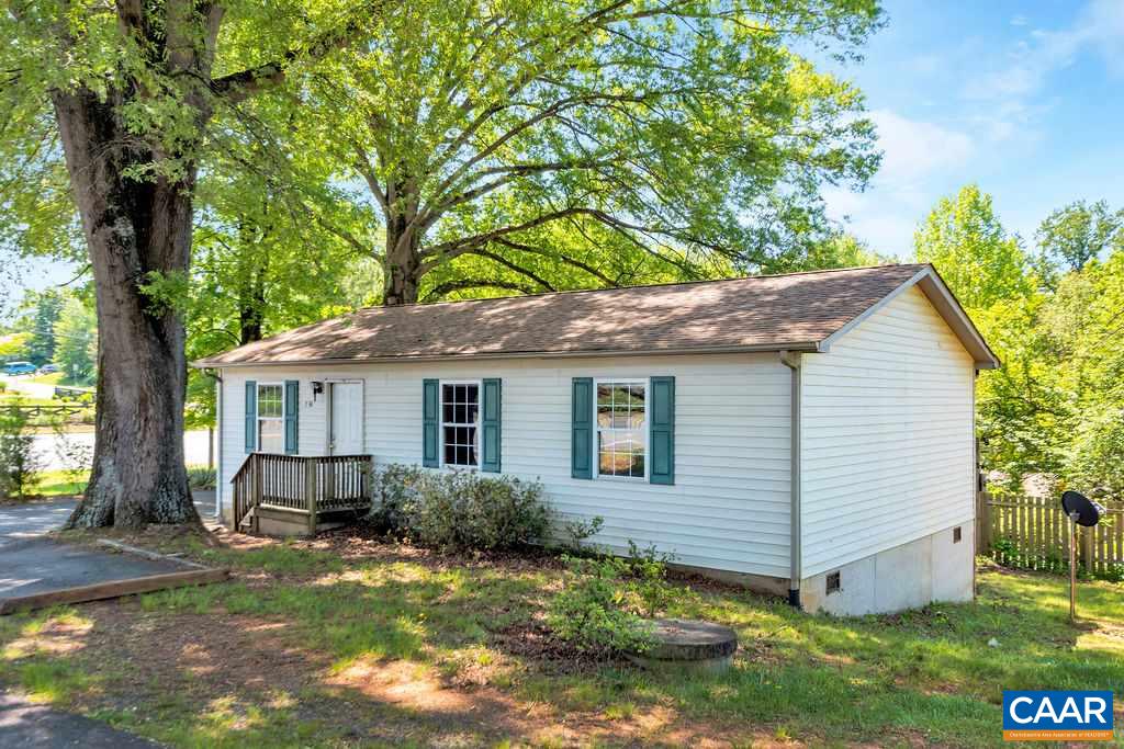 738 Rio Road East Charlottesville, VA 22901 - Photo 1 of 17 a backyard of a house with plants and large tree