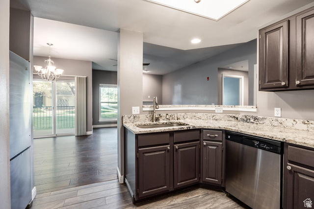900 Bitner Road, Unit M 17 Park City, UT 84098 - Photo 2 of 29 Kitchen with stainless steel appliances, light stone counters, light wood-style flooring, suspended lighting, and dark wood finish cabinets