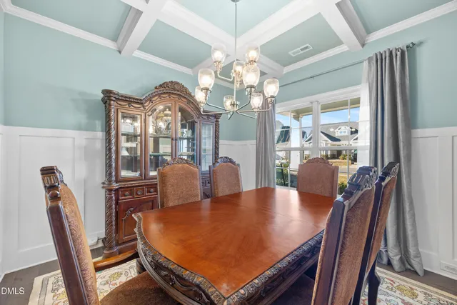 a living room with furniture a ceiling fan and a kitchen view