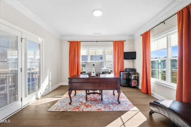 a living room with furniture a flat screen tv and kitchen view