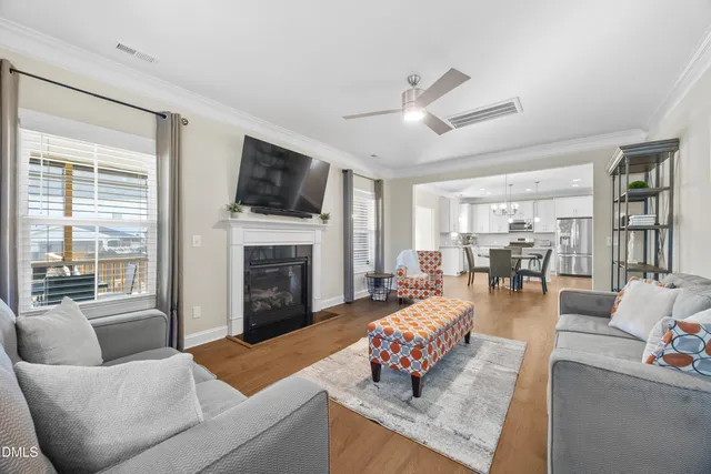 a kitchen with stainless steel appliances granite countertop grey cabinets a stove a sink and dishwasher