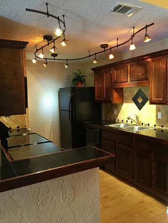 a kitchen with stainless steel appliances granite countertop a stove and a microwave