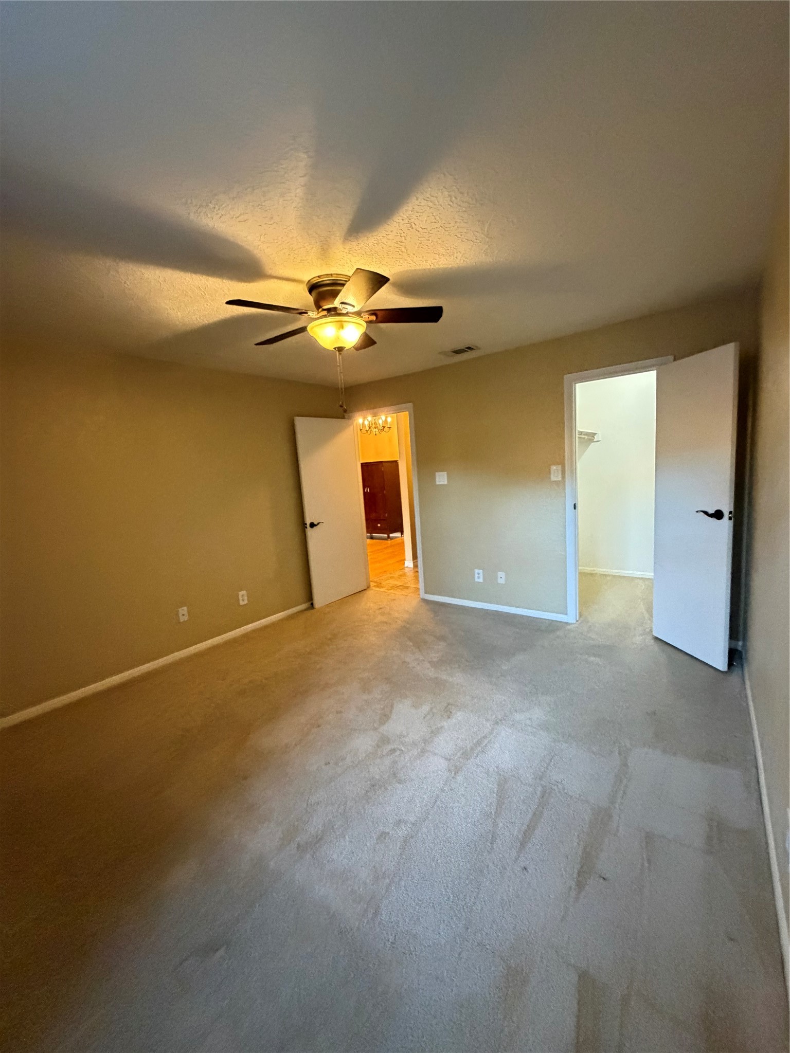 12755 Mill Ridge Drive, Unit 501 Cypress, TX 77429 - Photo 9 of 20 a view of an empty room with a chandelier fan