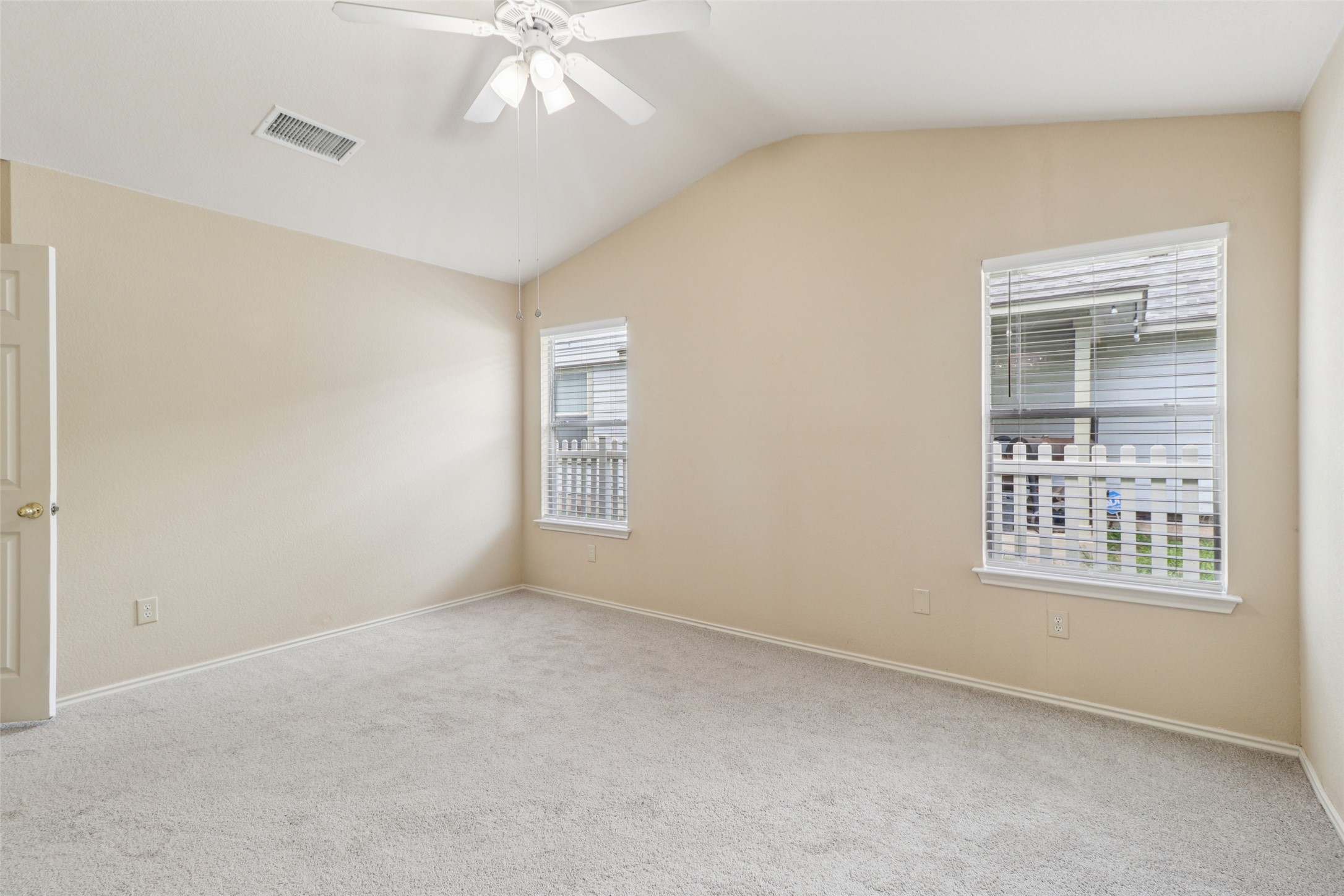 700 Scheel Road Kyle, TX 78640 - Photo 23 of 39 This room features a vaulted ceiling, a ceiling fan, and carpeted flooring