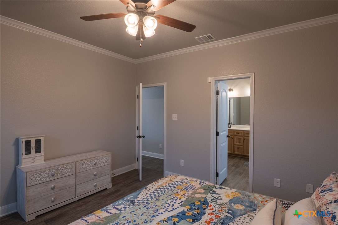 7909 McCulloch Road Temple, TX 76502 - Photo 32 of 46 a bedroom with a bed and a chandelier fan