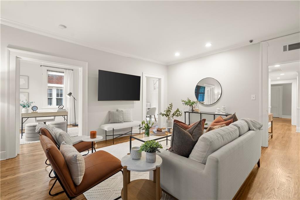 a living room with furniture and a flat screen tv