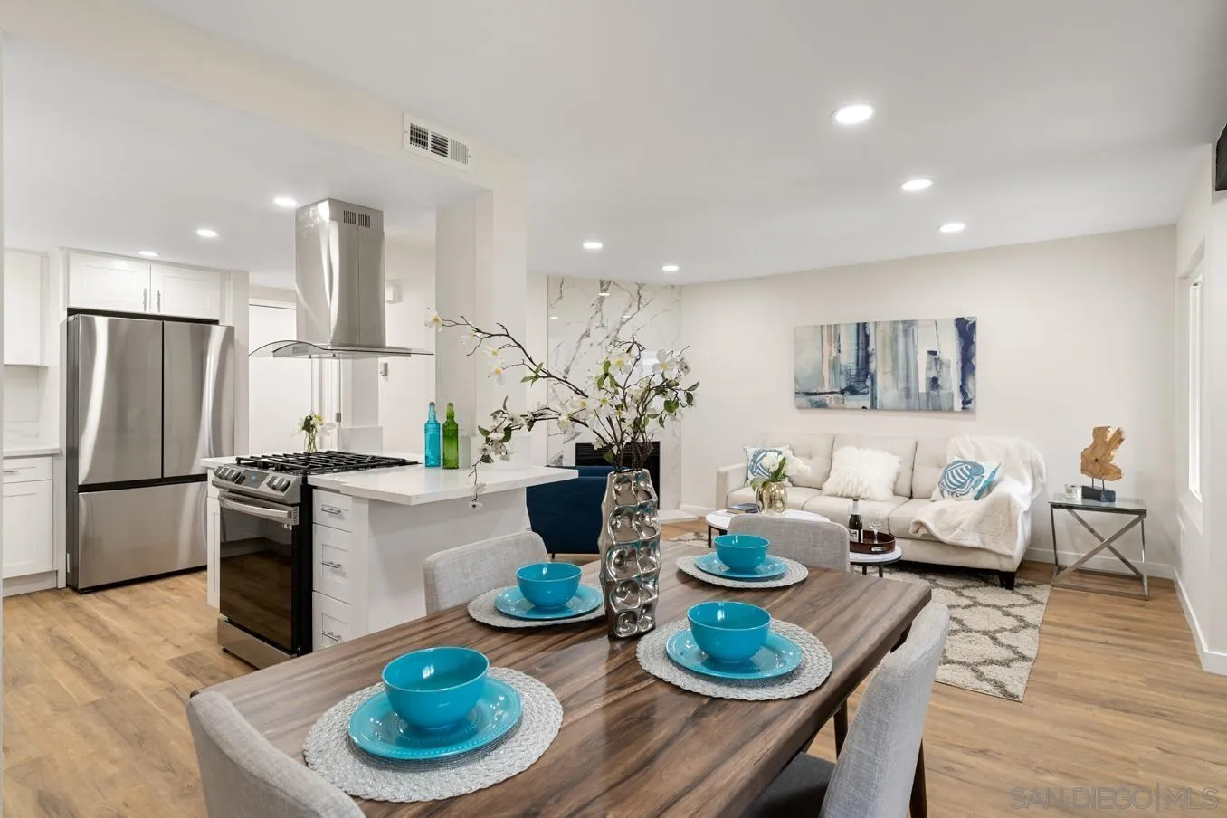 13221 Westmark Way, Unit 26 Poway, CA 92064 - Photo 5 of 42 a kitchen with stainless steel appliances granite countertop a stove a dining table and chairs