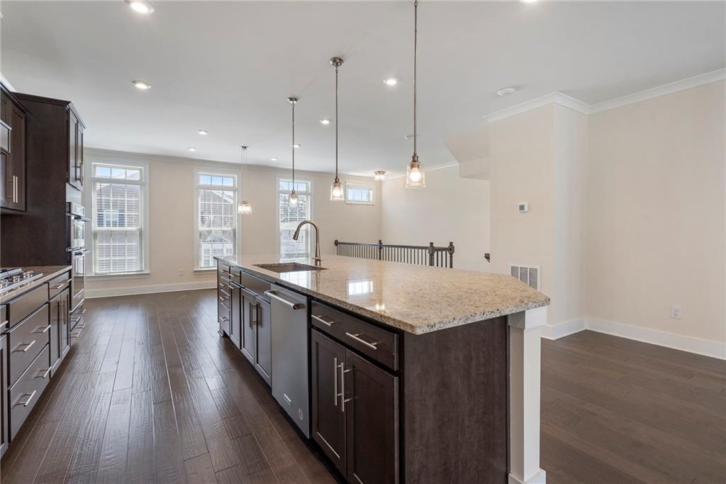 2059 Falls Park Way Decatur, GA 30033 - Photo 16 of 45 a kitchen with a kitchen island a sink stainless steel appliances and wooden floor