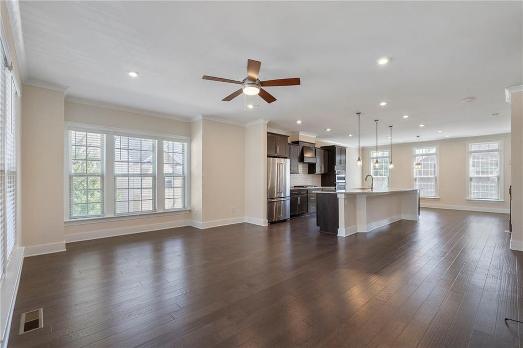 2059 Falls Park Way Decatur, GA 30033 - Photo 17 of 45 a view of a kitchen and an empty room with wooden floor and a kitchen