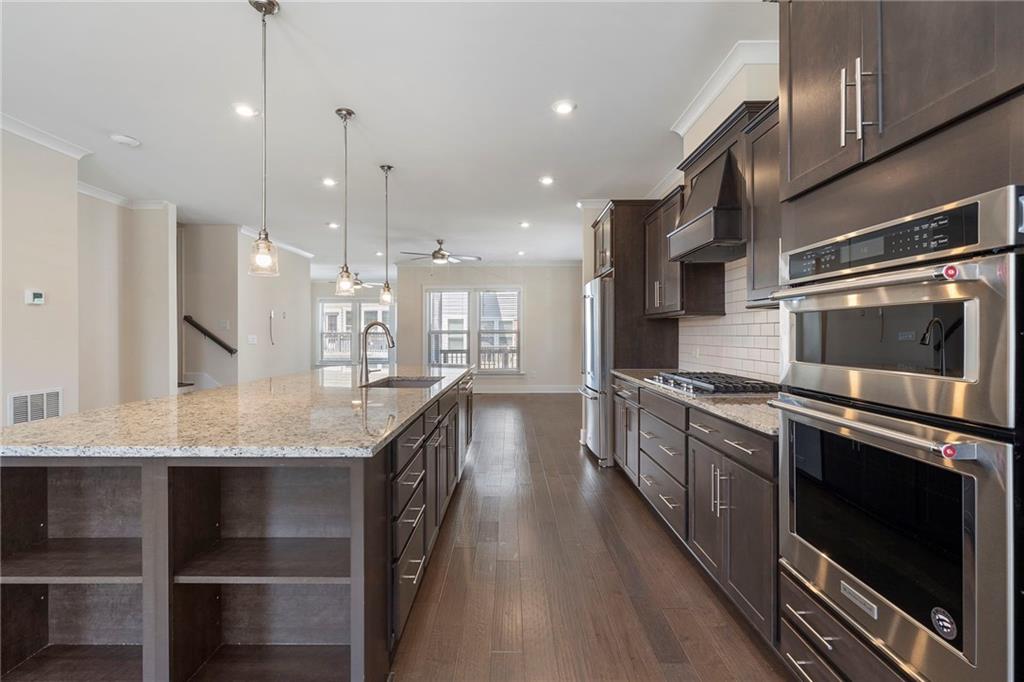 2059 Falls Park Way Decatur, GA 30033 - Photo 2 of 45 a large kitchen with granite countertop a large kitchen island and a sink