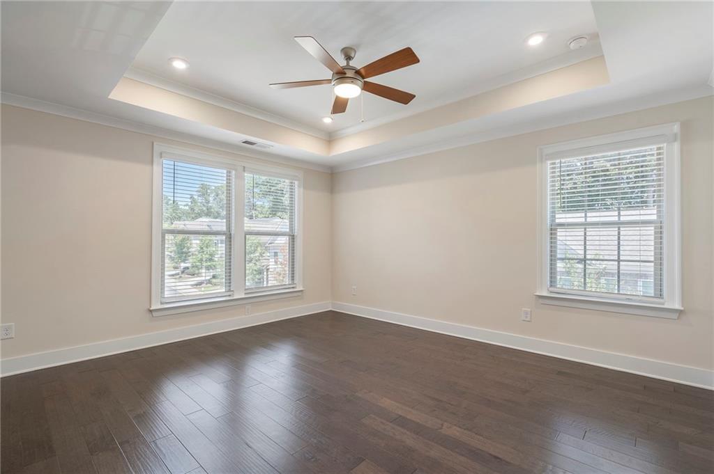 2059 Falls Park Way Decatur, GA 30033 - Photo 24 of 45 a view of an empty room with wooden floor and a ceiling fan