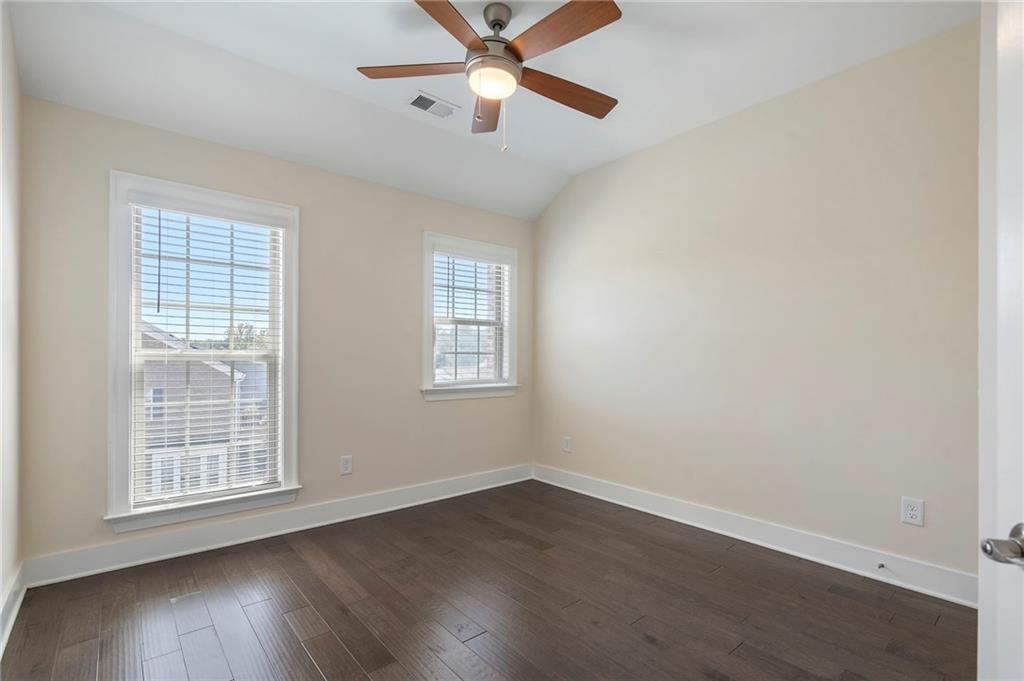 2059 Falls Park Way Decatur, GA 30033 - Photo 28 of 45 an empty room with wooden floor fan and windows