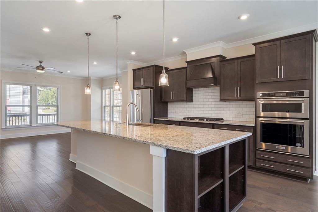 2059 Falls Park Way Decatur, GA 30033 - Photo 6 of 45 a kitchen with a stove kitchen island and a wooden floor