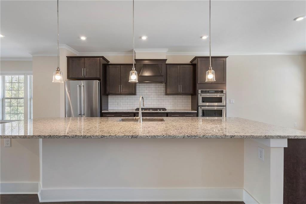 2059 Falls Park Way Decatur, GA 30033 - Photo 7 of 45 a large kitchen with a refrigerator a sink and a stove