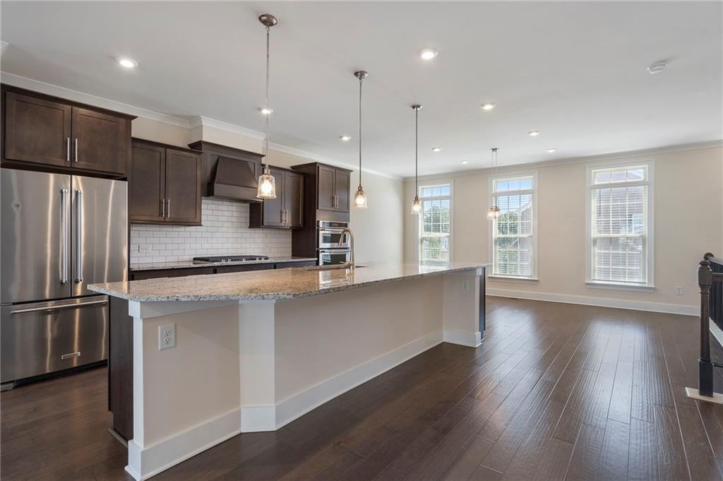 2059 Falls Park Way Decatur, GA 30033 - Photo 8 of 45 a large kitchen with a refrigerator a sink and a stove top oven
