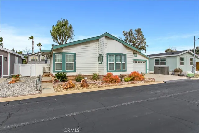 a view of a house with a patio and a yard