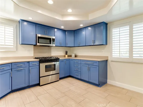 a kitchen with stainless steel appliances granite countertop a stove microwave and sink