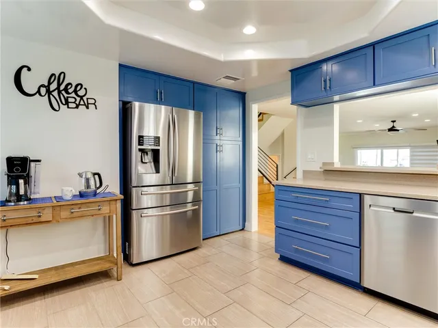 a kitchen with stainless steel appliances granite countertop a refrigerator and a stove