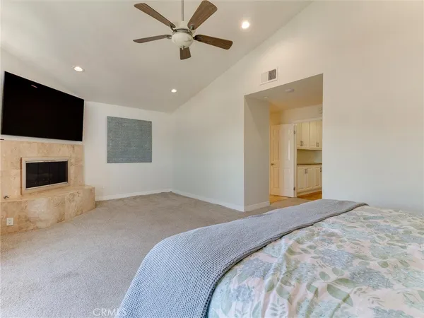 a bedroom with a large bed and a flat screen tv