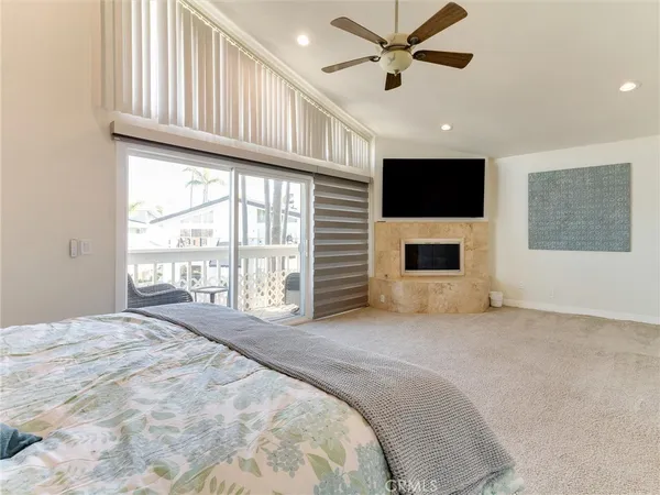 a large bedroom with a bed and a flat screen tv