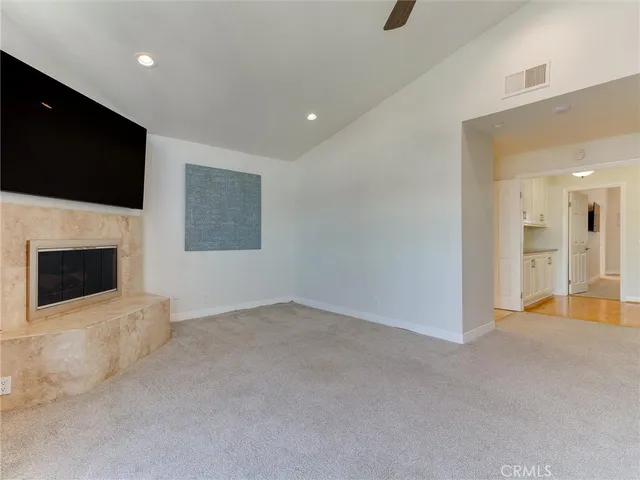a view of an empty room with a fireplace