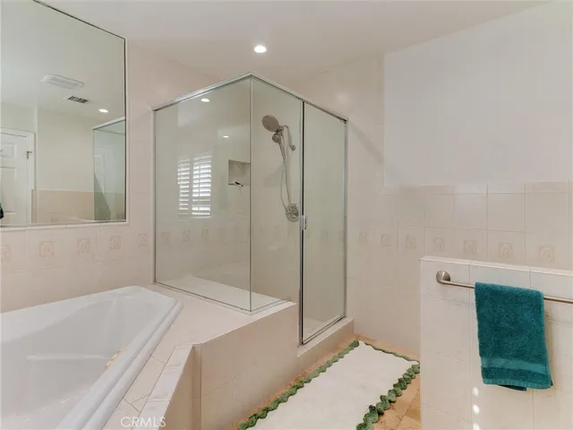 a bathroom with a bathtub and a shower