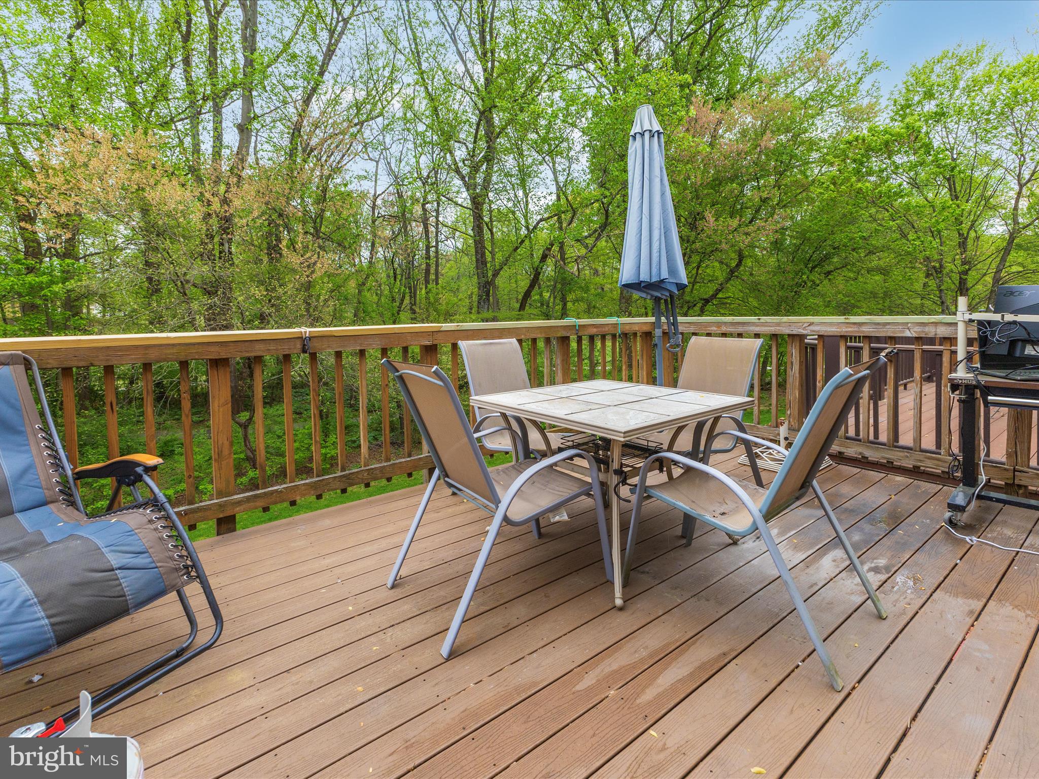 2544 Ambling Circle, Unit 31 Crofton, MD 21114 - Photo 40 of 52 a view of a deck with a table and chairs with wooden floor and fence