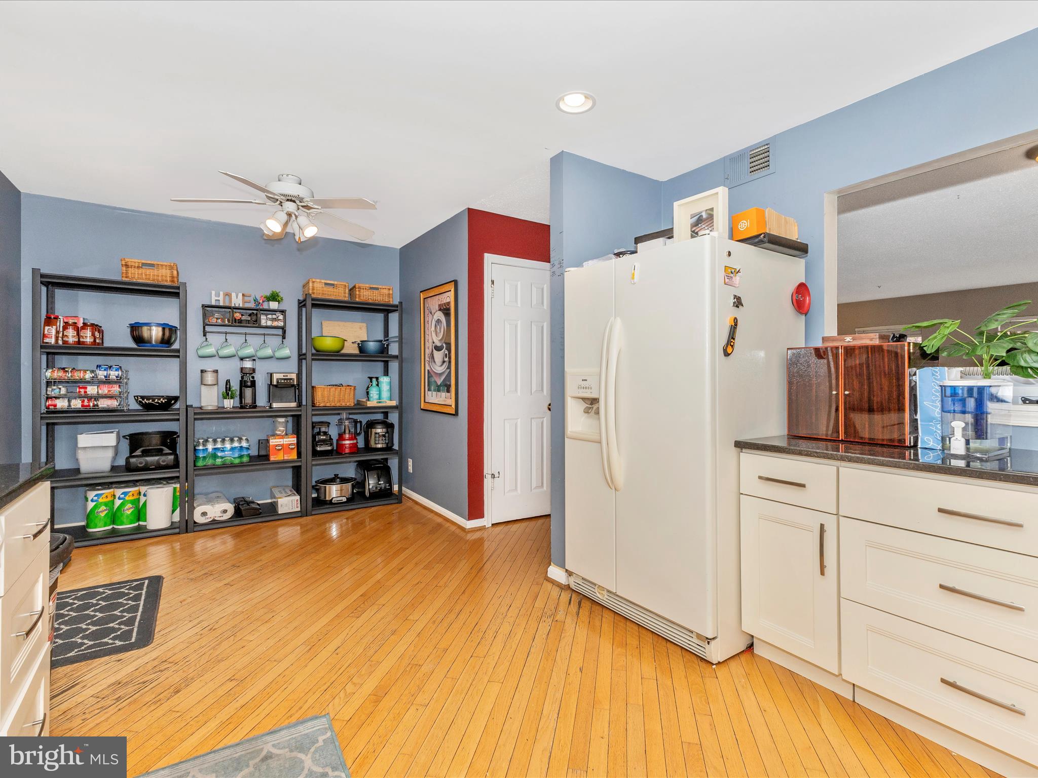2544 Ambling Circle, Unit 31 Crofton, MD 21114 - Photo 9 of 52 a kitchen with stainless steel appliances a refrigerator and a wooden floor