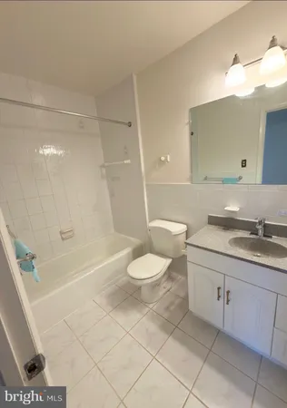 a bathroom with a granite countertop sink toilet a mirror and shower