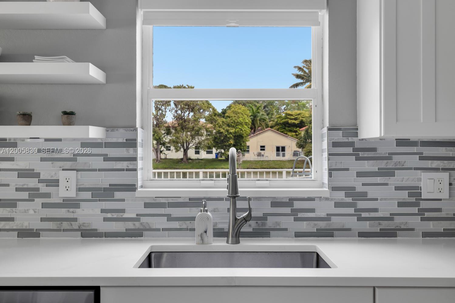 5861 South Sable Circle Margate, FL 33063 - Photo 11 of 56 a kitchen with a sink and a mirror